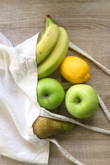 Various fruit in a canvas tote bag. Selective focus.