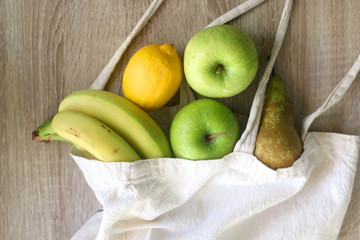 Various fruit in a canvas tote bag. Selective focus.