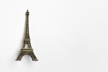 Fototapeta na wymiar The small Eiffel tower as a souvenir from Paris. Isolated on a white background.High-resolution photo