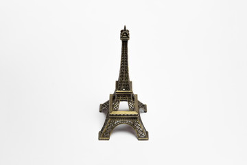 Fototapeta na wymiar The small Eiffel tower as a souvenir from Paris. Isolated on a white background.High-resolution photo