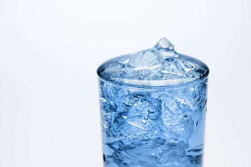 Close-up of a glass transparent glass filled with ice and water.