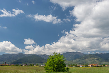 Wonderful glimpse of the Tuscan countryside in the municipality of Bientina, province of Pisa, Italy, with white clouds on Monte Serra
