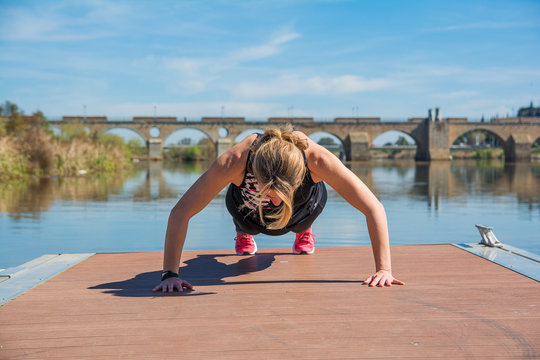 Sportwoman doing sit-ups and push-ups to train. sports