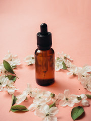 Glass bottles with oil, perfume. Spa. cosmetics. Blooming cherry.