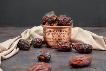 Food consumed in traditional Ramadan, date palm fruit in a copper container