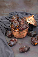 Food consumed in traditional Ramadan, date palm fruit in a copper container