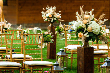 Decoration of the flower arrangement  for the wedding ceremony in the green forest .
