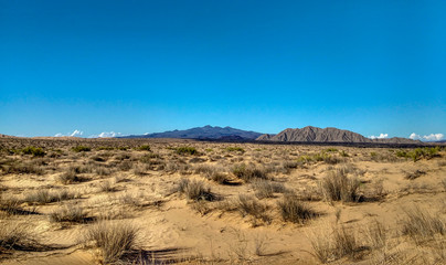 Mountain and sand dunes with vegetation landscape panorama
