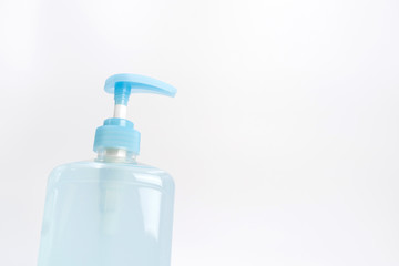 Isolated blue alcohol gel bottle and pump on white background.