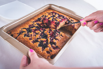 freshly baked pie in a pan with raspberries and cherries