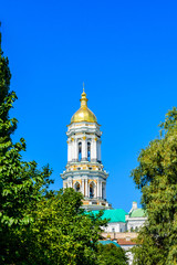 Fototapeta na wymiar Bell tower of the Kiev Pechersk Lavra against blue sky