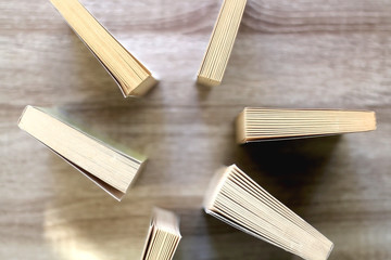 Paperback books on a wooden table. Top view.