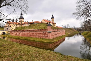 Naklejka premium Nesvizh, Belarus - March 2020. Beautiful medieval Nesvizh castle. Famous landmark in Belarus residential castle of the Radziwill family in Nesvizh. Medieval castle complex Niasvizh. UNESCO heritage 
