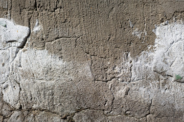 Close-up - gray-brown stone wall in the old facade of the house