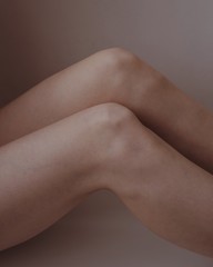 woman knees on the grey background