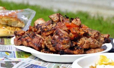 Food at a picnic. Picnic during the quarantine of COVID-19. Fresh vegetables and grilled meat.