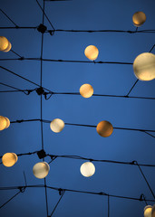 luminous street decorative round lights on a blue sky background