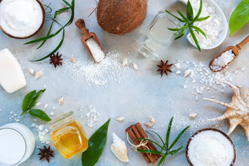 Beautiful SPA concept composition with coconut body care products on blue sky background