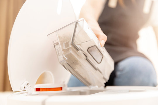 Woman Cleans Trash Bin Automatic Robot Vacuum Cleaner