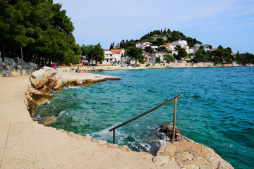 Rocky natural swimming pool in the Adriatic Sea near Tribunj in Croatia - Metal ladders