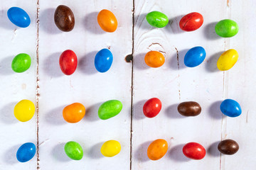 Colorful candy on white wooden background