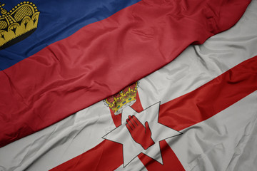 waving colorful flag of northern ireland and national flag of liechtenstein.