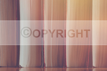 Copyright concept on the background of books with a sign.