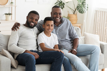 Mature African American Man Posing At Home With Son And Grandson