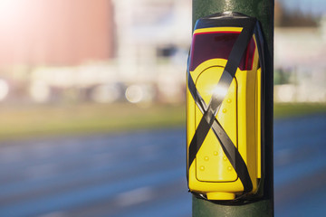 Turned off a traffic light button for crossing roadway with blurred bus. Crossed pedestrian yellow...