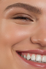 Half beauty portriet woman smiling at the camera with a snow-white smooth. Beautiful natural...