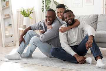 Male Generations. Portrait of preteen black boy hugging dad and grandfather