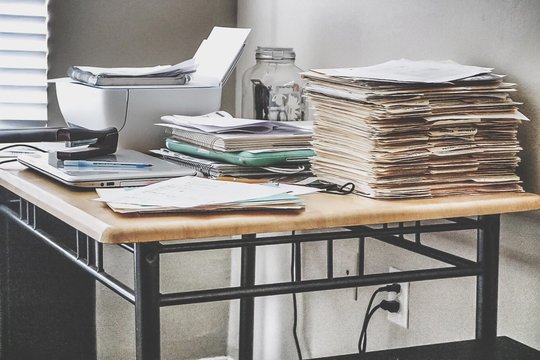 Stack Of Documents On Desk