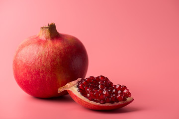 Fruit minimalism creative concept. Close up photo of ripe fresh red delicious pomegranate with...