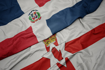 waving colorful flag of northern ireland and national flag of dominican republic.