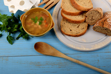 tripe in a small brown bowl with fresh green parsley next to dry bread
