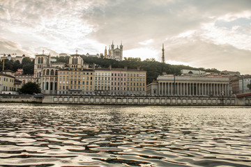 Main buildings of the city of Lyon at sunset with reflections of this in the water of the Rhone...