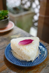 Jasmine rice served as a triangle topped with Orchid petals.
