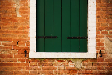 green window on red wall - Powered by Adobe