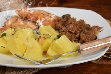 boiled potatoes with fried cabbage, sprinkled with dill, chicken cutlet, traditional Polish dish