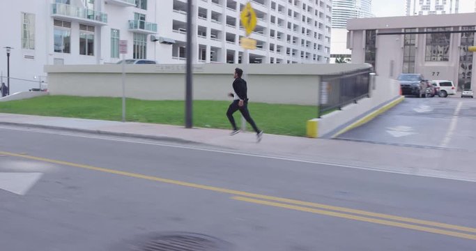 Man in suit running on street