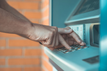 Entering a credit card code on the ATM keyboard