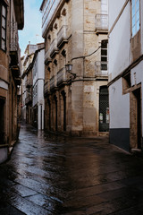 Fototapeta na wymiar Pedestrian street after the rain in old town Santiago de Compostela, Galicia
