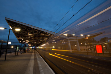 Fototapeta na wymiar Train driving away from the train station at night