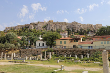 In Athens, Greece, clumn ruins on the original site of Hadrian's Library, dating back to AD 132, are shown in the foreground, with the ancient Acropolis in the background.
