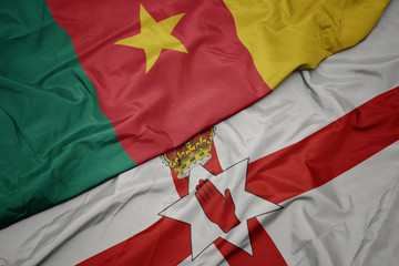 waving colorful flag of northern ireland and national flag of cameroon.