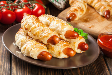 Rolled hot dog sausages baked in puff pastry