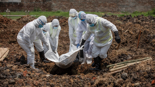 Members of Al-Markazul Islami Bangladesh carry a Person to the grave for funeral at Khilgaon Taltola Graveyard in Bangladesh on Friday morning April 24,2020.Photo: Saikat Bhadra