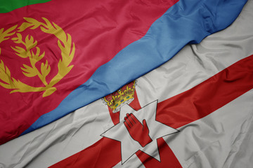 waving colorful flag of northern ireland and national flag of eritrea.