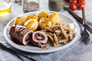 Pork rolls stuffed with vegetables served with potatoes