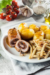 Pork rolls stuffed with vegetables served with potatoes